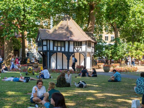 London park in warm weather with people relaxing London park in warm weather with people relaxing