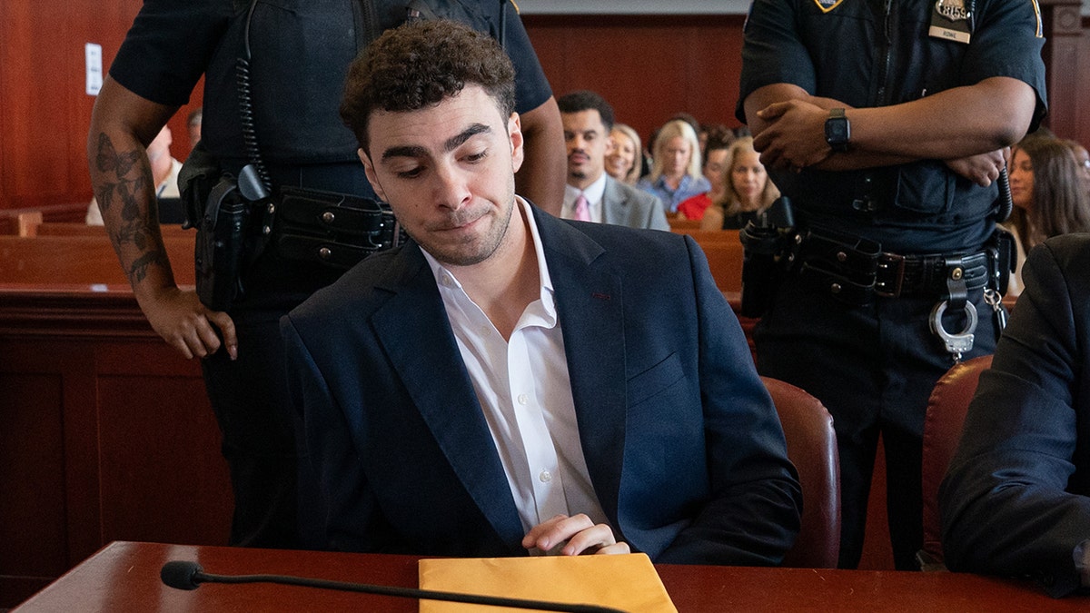 Luigi Mangione standing in a courtroom in Manhattan Criminal Court in New York City