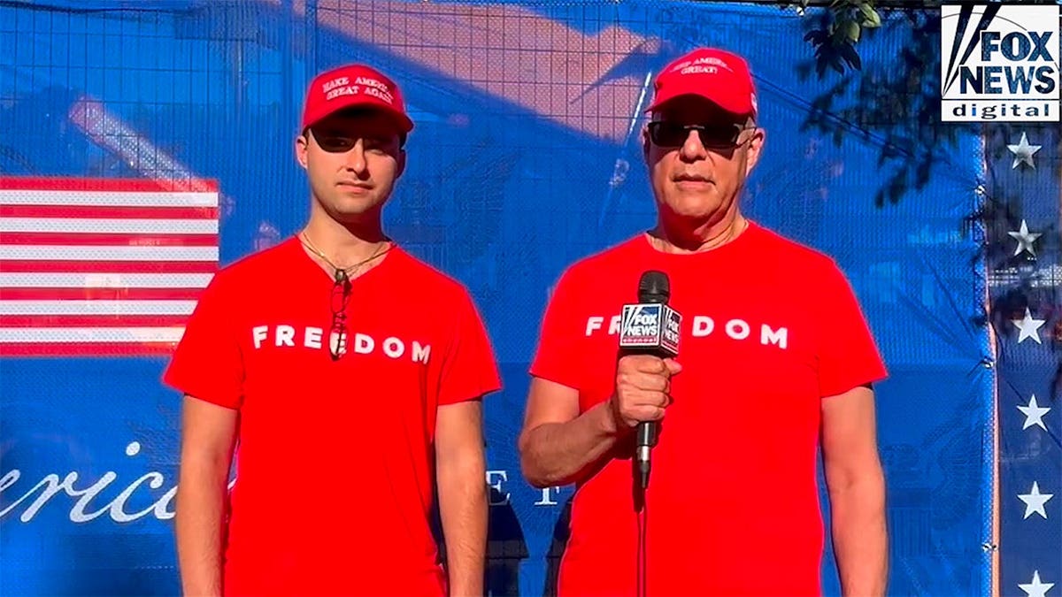 Two men in red shirts talking to Fox reporter