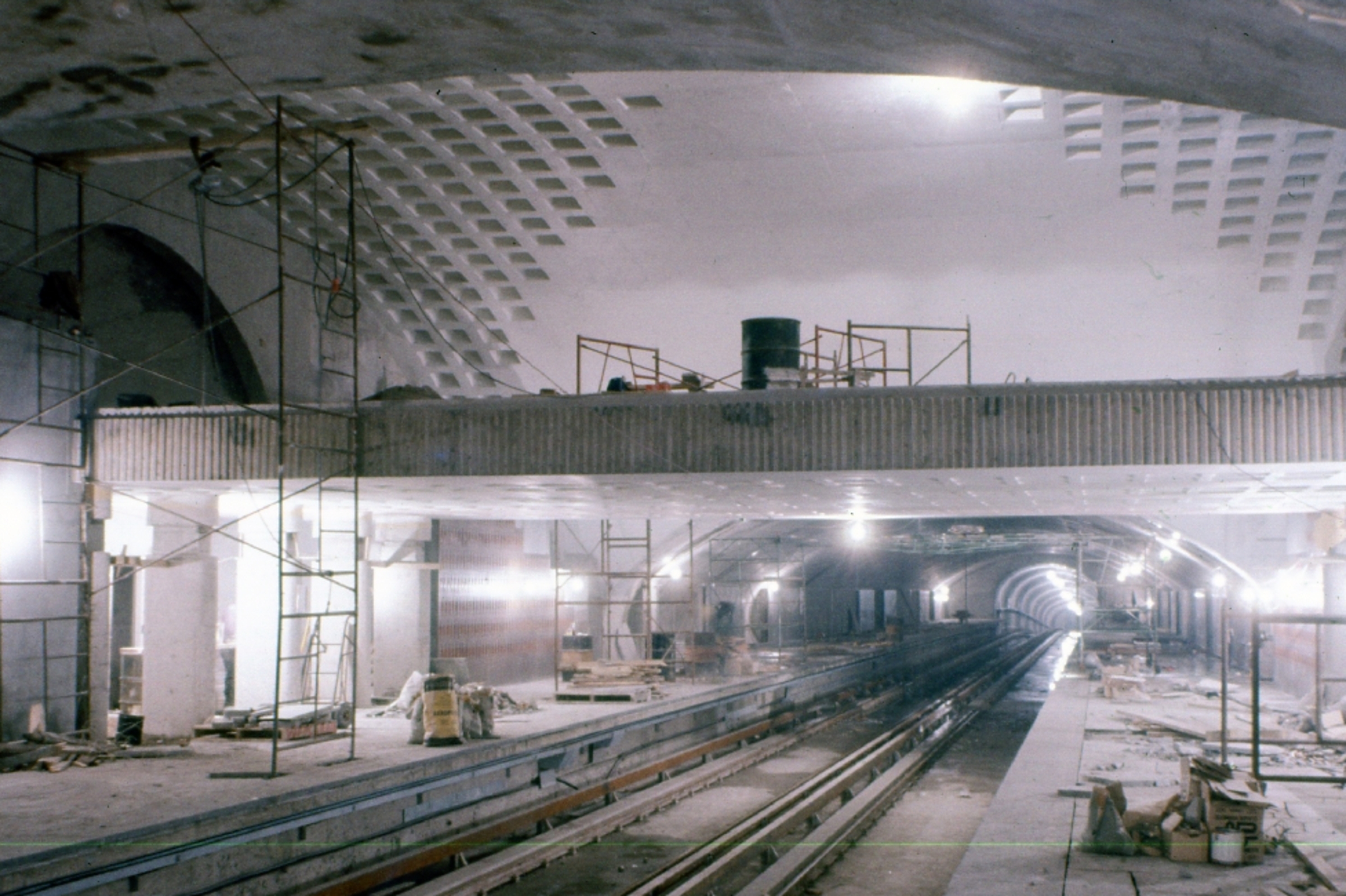 A métro station under construction, with the platforms and a walkway visible.