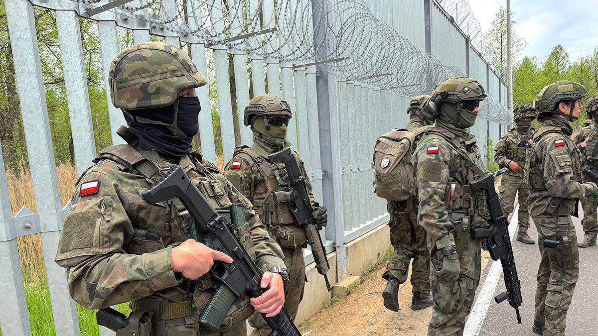 Polish soldiers standing watch near the Belarus border.