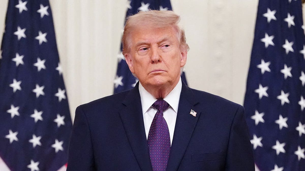 President Donald Trump in front of American flags