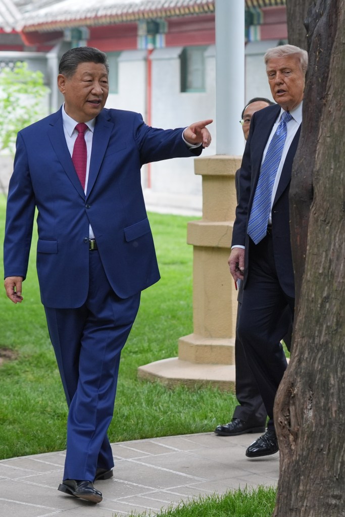 Chinese president Xi Jinping and US president Donald Trump walk and talk