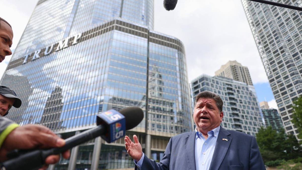 Illinois Gov. J.B. Pritzker speaking to reporters outside Trump Tower in Chicago