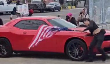 Anti-ICE protester hit by car while waving upside-down US flag outside Delaney Hall