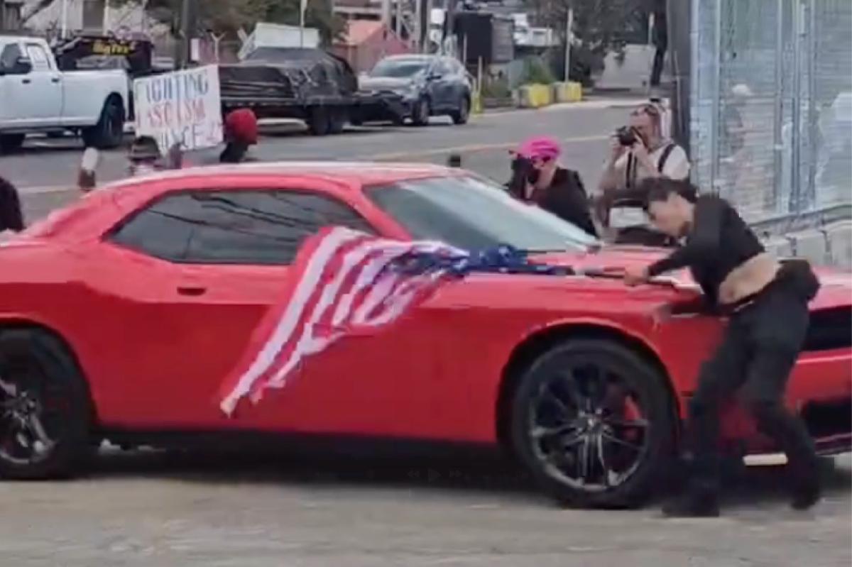 Anti-ICE protester hit by car while waving upside-down US flag outside Delaney Hall