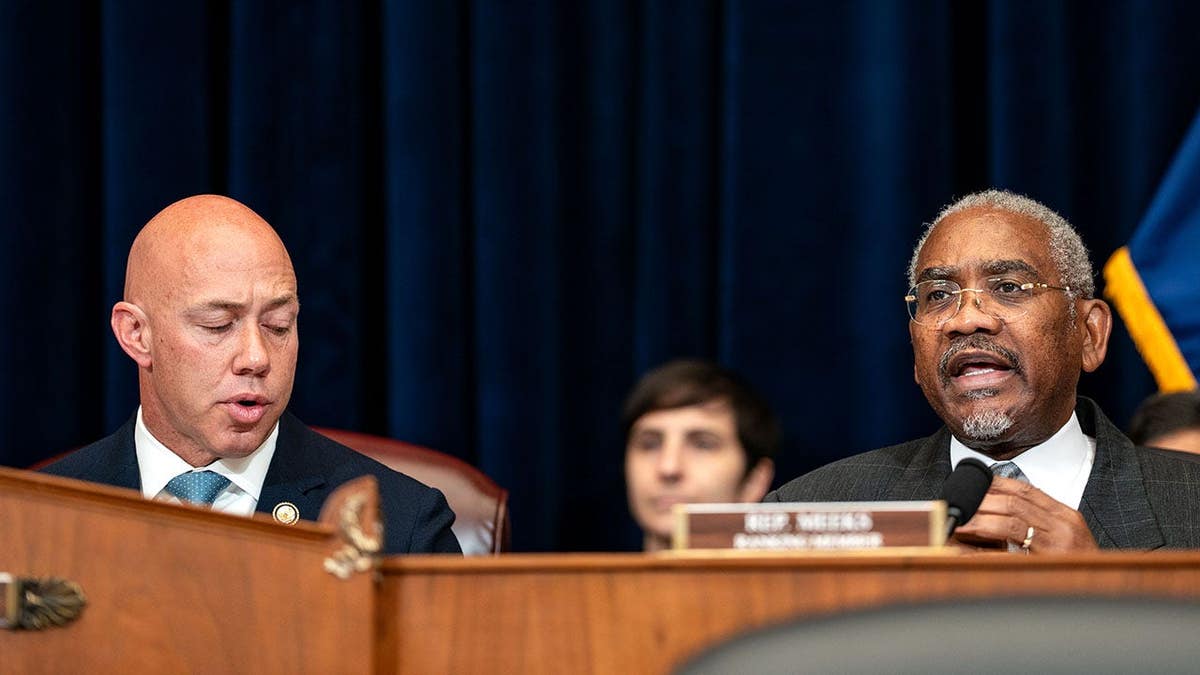 Rep. Brian Mast turning as Rep. Gregory Meeks speaks during House Foreign Affairs Committee hearing