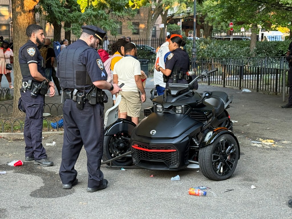 Police officers investigating a three-wheeled scooter after it reportedly struck several pedestrians in a park.