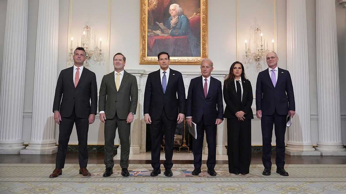 Michael Needham, Mike Waltz, Marco Rubio, Michel Issa, Nada Hamadeh Moawad, and Yechiel Leiter standing in a row inside the State Department