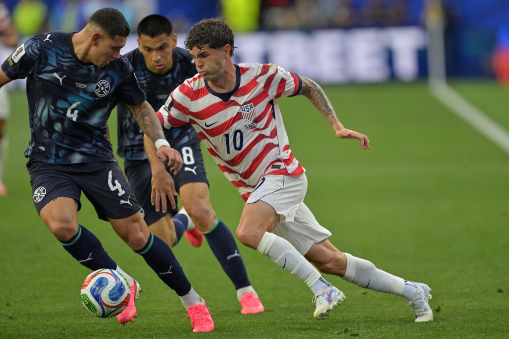 United States' Christian Pulisic (10) runs with the ball during the World Cup Group D soccer match against Paraguay.