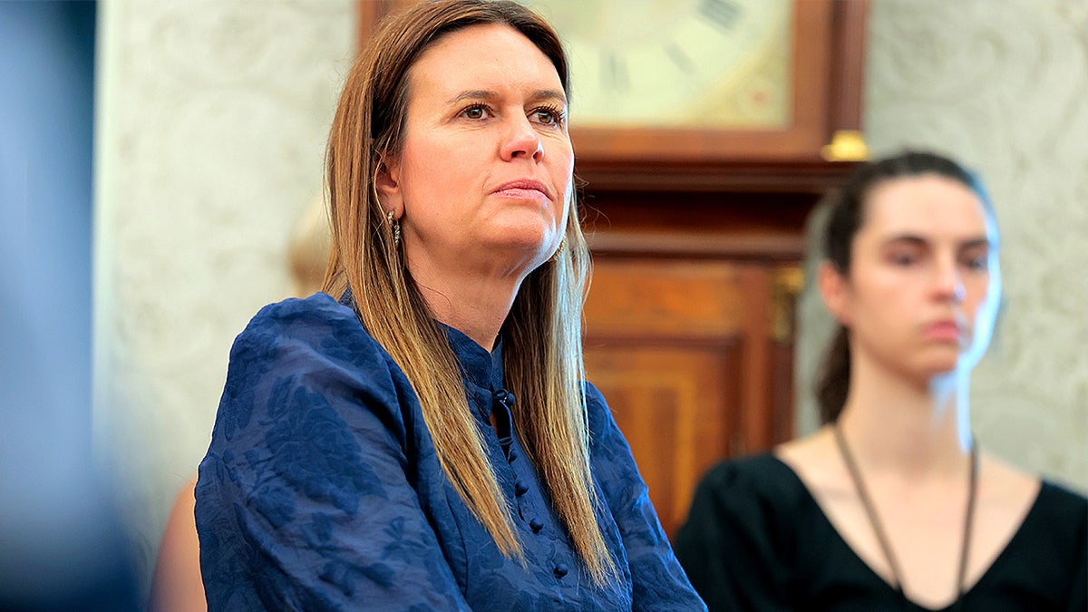 Arkansas Gov. Sarah Huckabee Sanders standing in the Oval Office with President Donald Trump