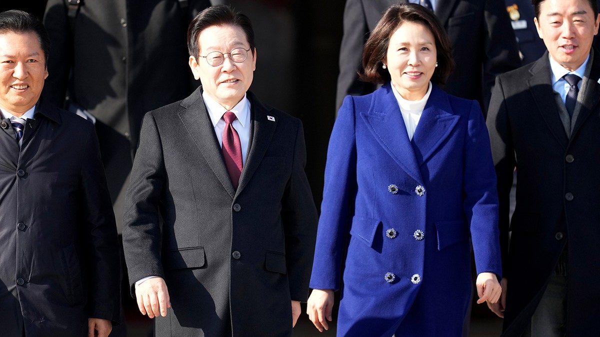 South Korean President Lee Jae Myung walking with wife Kim Hea Kyung at Seoul airport