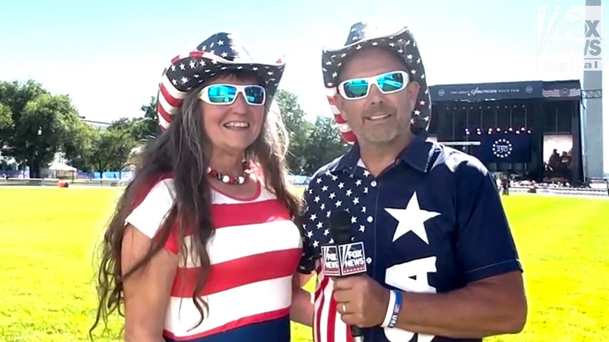 couple in american flag attire with fox news mic