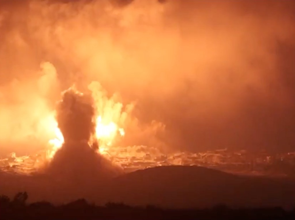 Explosion with plumes of smoke and debris in the village of Majdal Zoun.