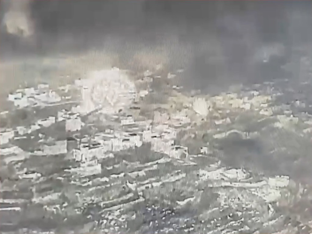 Explosion sending plumes of smoke and debris into the air over the village of Majdal Zoun.