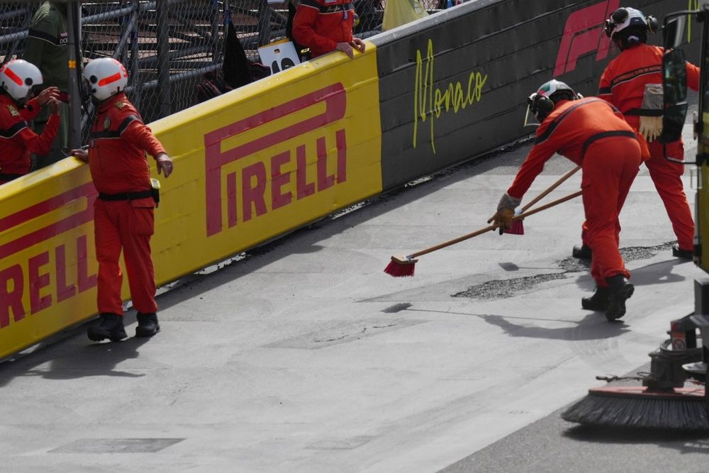 The track is swept during a red flag delay.