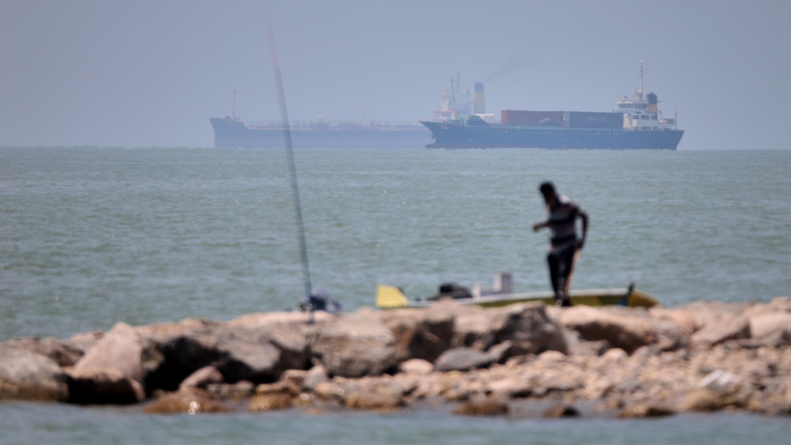 Iranian drones attack Bahrain and a ship is struck in the strait after US airstrikes