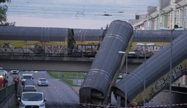 2 freight trains collide in Germany, sending 2 wagons plunging off bridge; 1 dead