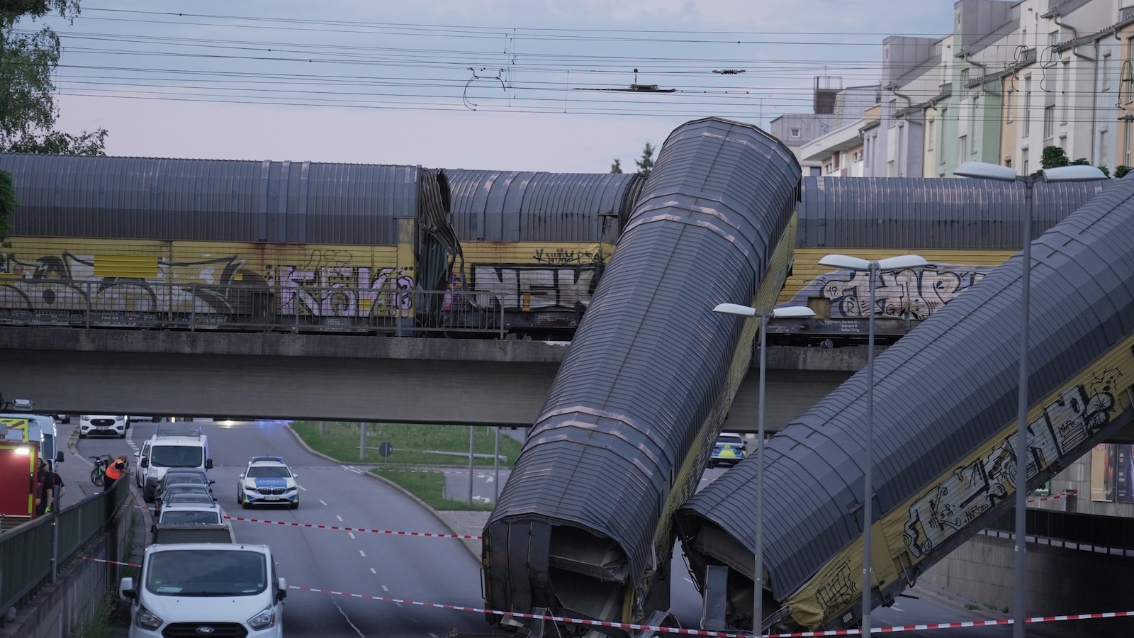 2 freight trains collide in Germany, sending 2 wagons plunging off bridge; 1 dead