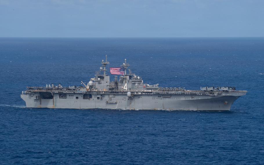 A warship travels atop the ocean.