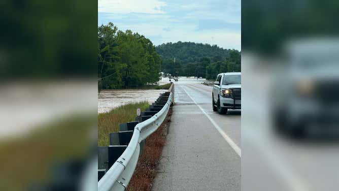 Water from the Black River nearly passes a road in Lesterville, MO.