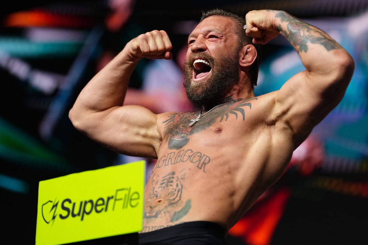 Conor McGregor steps on the scale during the UFC 329 ceremonial weigh-in at T-Mobile Arena