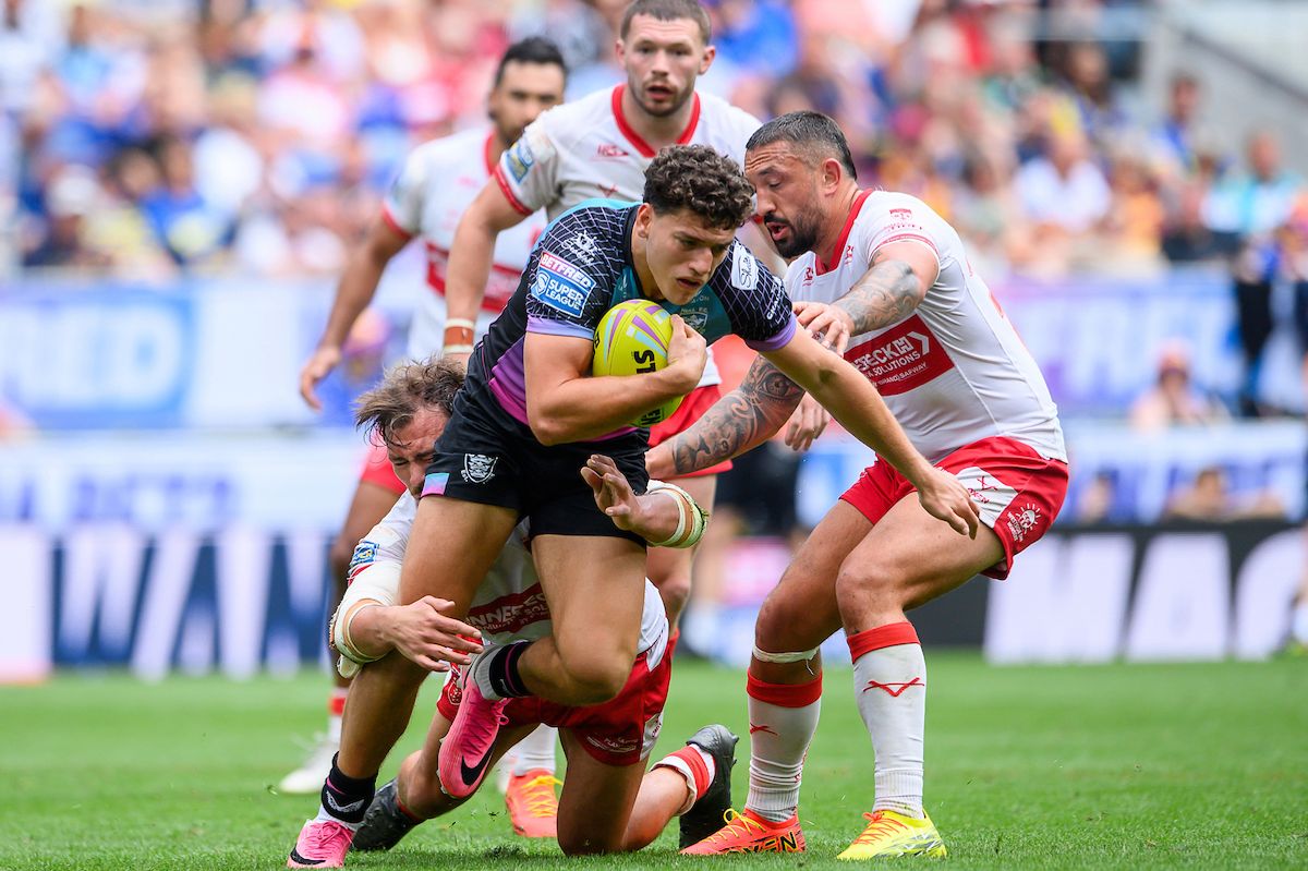 Hull FC's Lewis Martin is tackled by Hull KR's Jai Whitbread and Elliot Minchella.