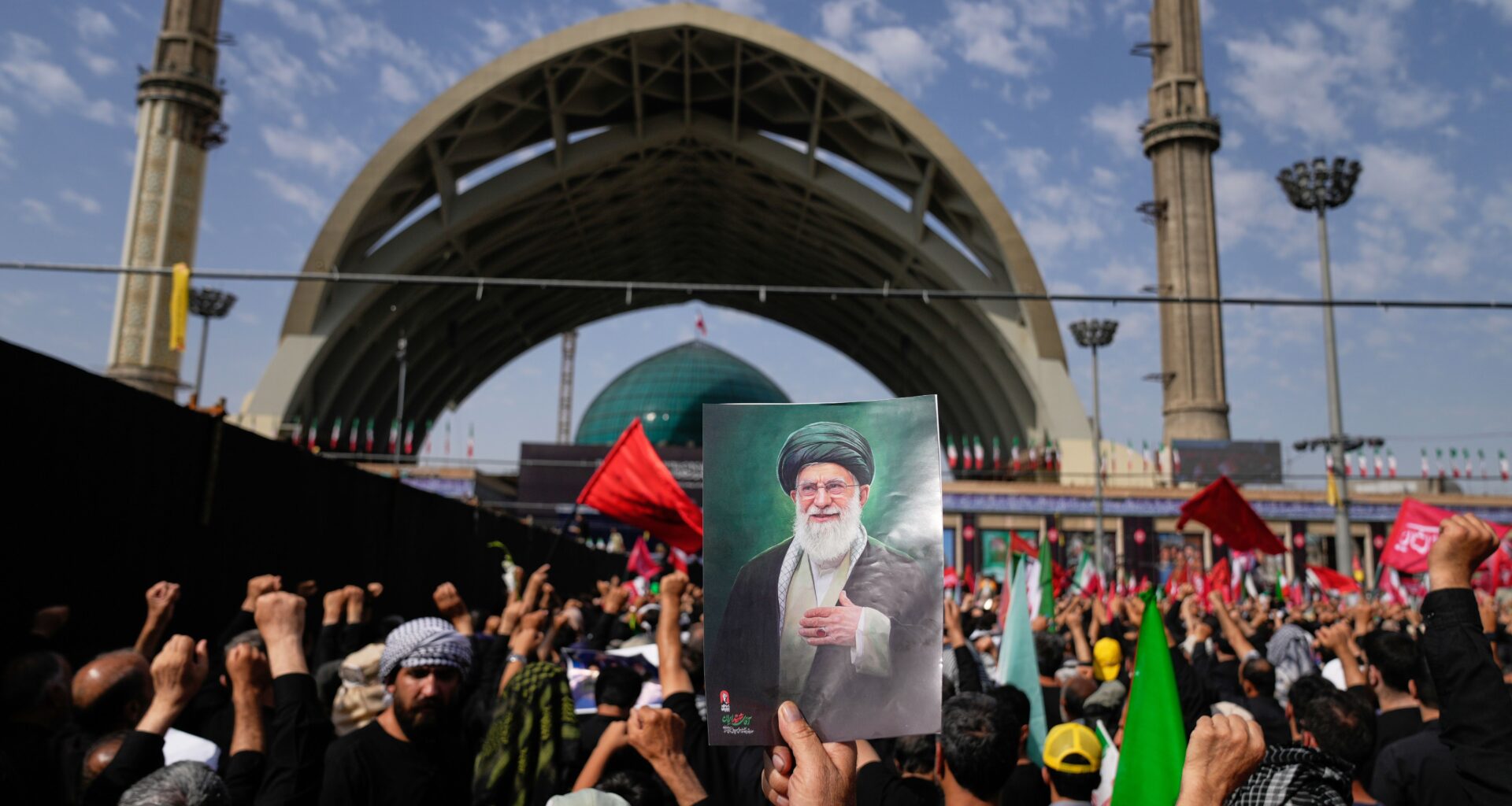A mourner holds a portrait of the late Iranian Supreme Leader Ayatollah Ali Khamenei as mourners gather for the start of the dayslong funeral ceremonies for Khamenei and members of his family at the Imam Khomeini Mosalla Grand Mosque in Tehran, Iran, Saturday, July 4, 2026. (AP Photo/Altaf Qadri)