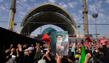 A mourner holds a portrait of the late Iranian Supreme Leader Ayatollah Ali Khamenei as mourners gather for the start of the dayslong funeral ceremonies for Khamenei and members of his family at the Imam Khomeini Mosalla Grand Mosque in Tehran, Iran, Saturday, July 4, 2026. (AP Photo/Altaf Qadri)
