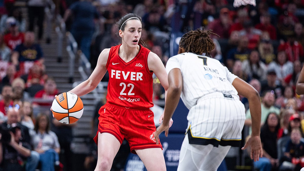 May 17, 2025; Indianapolis, Indiana, USA; Indiana Fever guard Caitlin Clark (22) dribbles the ball while Chicago Sky guard Ariel Atkins (7) defends in the first half at Gainbridge Fieldhouse. Mandatory Credit: Trevor Ruszkowski-Imagn Images