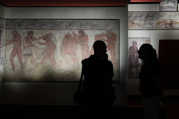 Reporters visit the frescoes, dating from 330–310 B.C., exhibited in the reconstruction of the François Tomb, an Etruscan tomb, at the Villa Giulia Etruscan Museum in Rome, Tuesday, June 30, 2026. (AP Photo/Alessandra Tarantino)