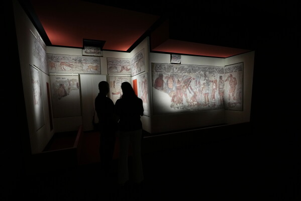 Reporters visit the frescoes, dating from 330–310 B.C., exhibited in the reconstruction of the François Tomb, an Etruscan tomb, at the Villa Giulia Etruscan Museum in Rome, Tuesday, June 30, 2026. (AP Photo/Alessandra Tarantino)