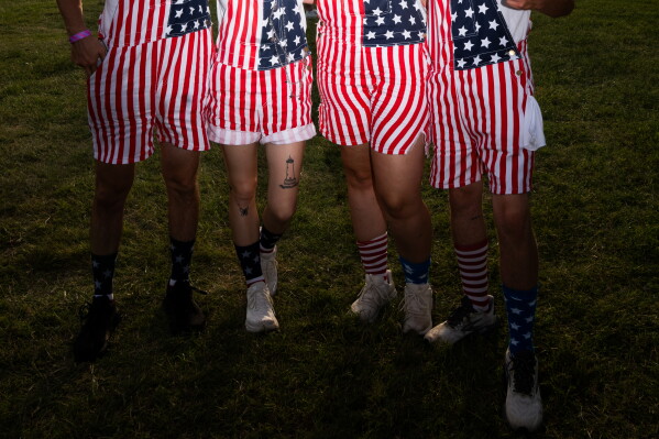 Fans wear America-themed clothing during the UFC Fan Fest on the White House Ellipse ahead of UFC Freedom 250 on the South Lawn, Sunday, June 14, 2026, in Washington. (AP Photo/Allison Robbert)