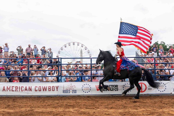 People watch Rodeo250 at the Great American State Fair on the National Mall, Saturday, June 27, 2026, in Washington. (AP Photo/Jen Golbeck)