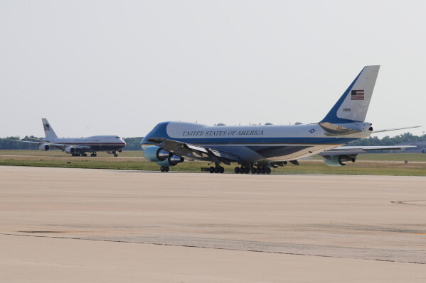 The newly designated Air Force One, left, with president Donald Trump on board, takes off on the runway as the old version of the plane is in the foreground, at Joint Base Andrews, Md., Wednesday, July 1, 2026 (AP Photo/Luis M. Alvarez)