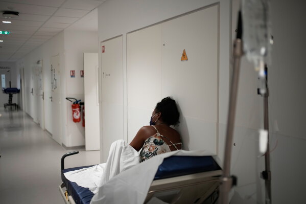 A patient waits before being treated at the emergency department of the Paris-Saclay Hospital, outside Paris, Tuesday June 30, 2026. (AP Photo/Christophe Ena )