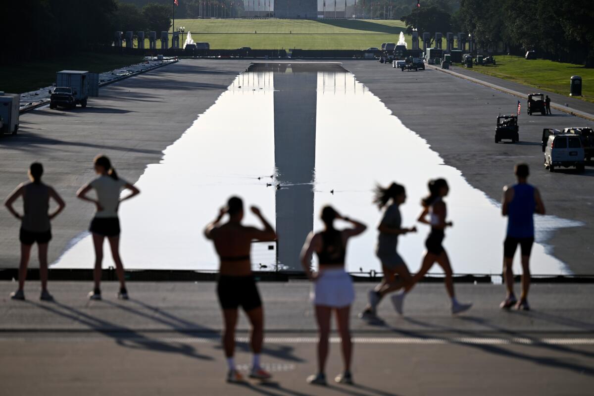 People watch as water fills the Reflecting Pool.