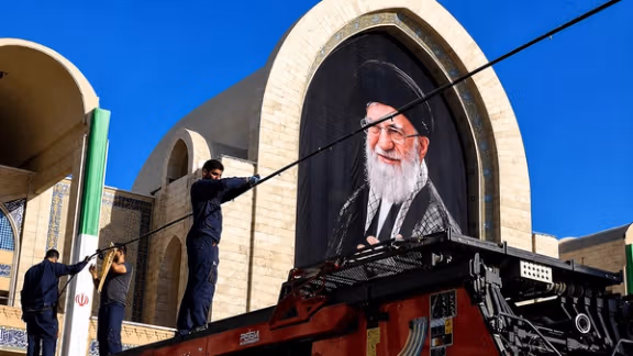 Workers arrange decorations during funeral preparations for Iran's former Supreme Leader Ali Khamenei. (undated)