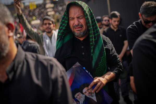A mourner weeps as he attends the start of the dayslong funeral ceremonies for the late Iranian Supreme Leader Ayatollah Ali Khamenei and members of his family at the Imam Khomeini Mosalla Grand Mosque in Tehran, Iran, Saturday, July 4, 2026. (AP Photo/Altaf Qadri)