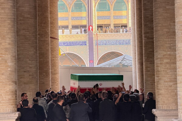 The coffin of the late Iranian Supreme Leader Ayatollah Ali Khamenei is carried into the Mosalla Grand Mosque ahead of his funeral ceremonies in Tehran, Iran, Friday, July 3, 2026. (AP Photo/Vahid Salemi)