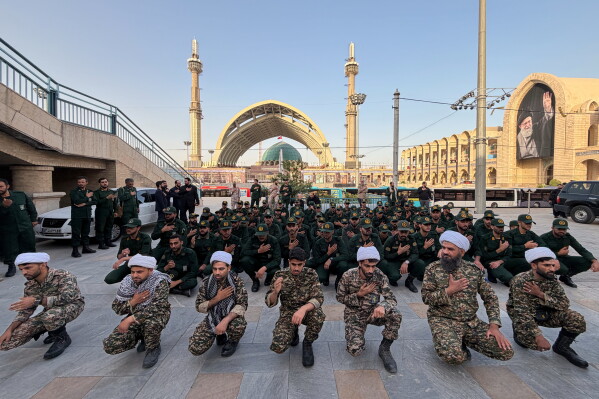 Revolutionary Guard members and clerics mourn on the esplanade of the Imam Khomeini Mosalla Grand Mosque as preparations are underway ahead of the dayslong funeral ceremonies for the late Iranian Supreme Leader Ayatollah Ali Khamenei in Tehran, Iran, Friday, July 3, 2026. (AP Photo/Vahid Salemi)