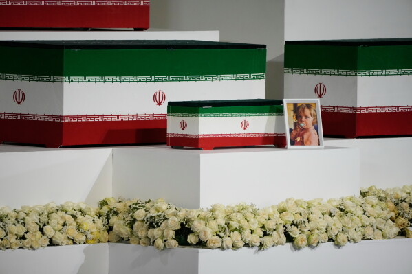 The casket of the late Iranian Supreme Leader Ayatollah Ali Khamenei's granddaughter, Zahra Mohammadi Golpayegani, is displayed alongside the caskets of Khamenei and other members of his family during a viewing ceremony ahead of the dayslong funeral ceremonies at the Imam Khomeini Mosalla Grand Mosque in Tehran, Iran, Friday, July 3, 2026. (AP Photo/Vahid Salemi)