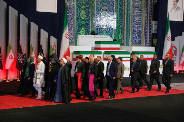 Iranian religious leaders and other mourners walk past the coffins of the late Iranian Supreme Leader Ayatollah Ali Khamenei and members of his family during a viewing ceremony ahead of the dayslong funeral ceremonies at the Imam Khomeini Mosalla Grand Mosque in Tehran, Iran, Friday, July 3, 2026. (AP Photo/Vahid Salemi) The religious leaders are Iranian, not foreigners
