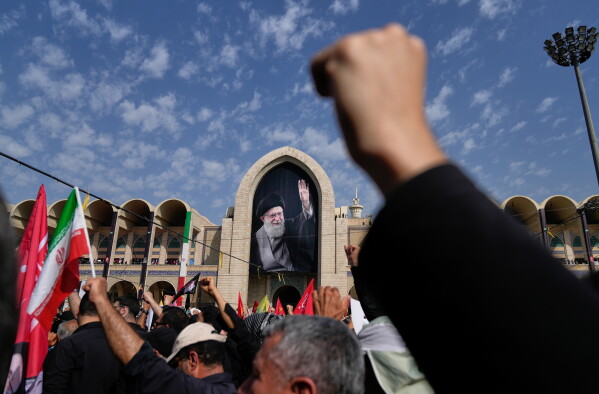 Mourners attend the start of the dayslong funeral ceremonies for the late Iranian Supreme Leader Ayatollah Ali Khamenei and members of his family at the Imam Khomeini Mosalla Grand Mosque in Tehran, Iran, Saturday, July 4, 2026. (AP Photo/Altaf Qadri)