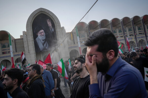 A mourner weeps during the funeral ceremonies for slain Iranian Supreme Leader Ayatollah Ali Khamenei and members of his family at the Imam Khomeini Mosalla Grand Mosque in Tehran, Iran, Saturday, July 4, 2026. (AP Photo/Altaf Qadri)