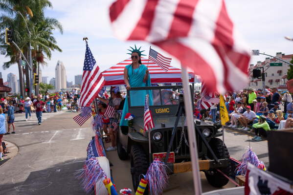 People look on during an Independence Day parade Saturday, July 4, 2026, in Coronado, Calif. (AP Photo/Gregory Bull)