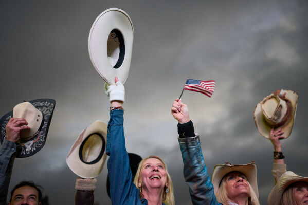 People raise their hats while dancing during celebrations marking the 250th anniversary of U.S. independence in Buenos Aires, Argentina, Saturday, July 4, 2026.(AP Photo/Rodrigo Abd)
