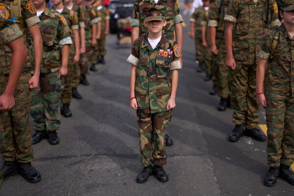 Members of the Young Marines stand at attention before an Independence Day parade Saturday, July 4, 2026, in Coronado, Calif. (AP Photo/Gregory Bull)
