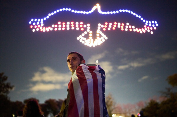 Leandro Braga watches a drone exhibition at celebrations marking the 250th anniversary of U.S. independence in Buenos Aires, Argentina, Saturday, July 4, 2026. (AP Photo/Rodrigo Abd)