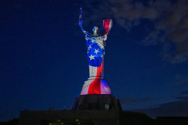 The Mother Ukraine Monument is illuminated in the colors of the U.S. flag in honor of the American 250th Independence Day, in Kyiv, Ukraine, Saturday, July 4, 2026. (AP Photo/Efrem Lukatsky)